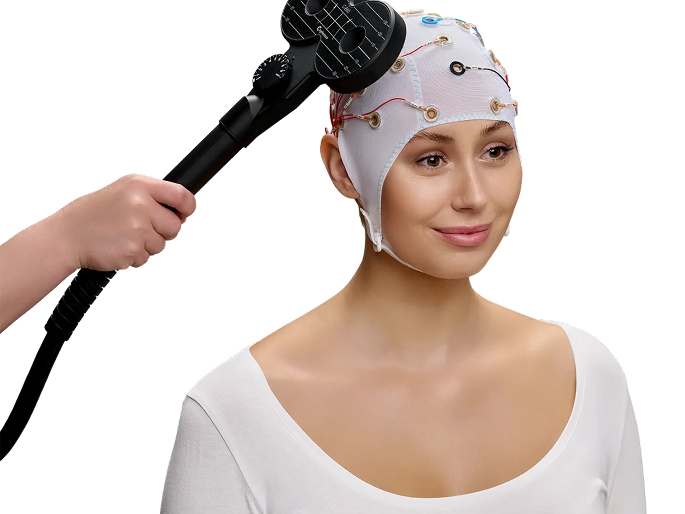 Woman wearing an electrode cap and a stimulation tool next to her head.